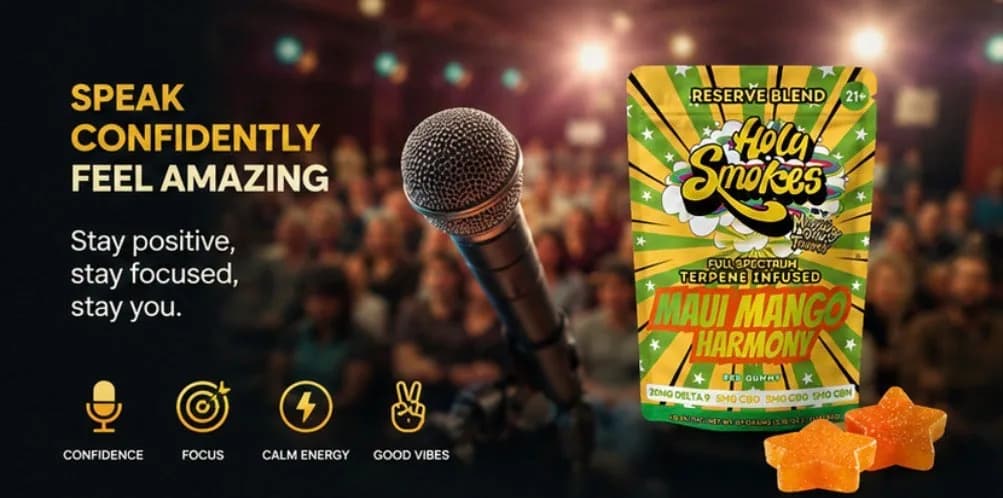 The Maui Mango pouch and two orange star gummies at the right of a dark image showing a microphone on a stand in front of a seated audience.